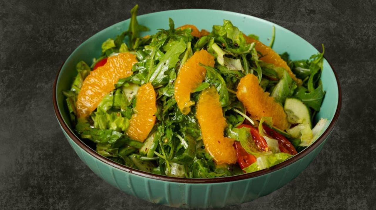 Fresh arugula salad with orange and chilli
