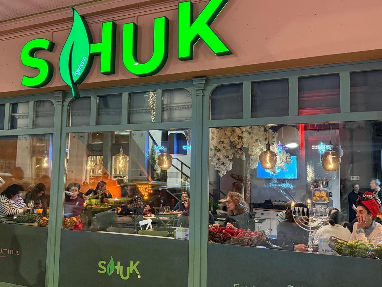 SHUK storefront on Ermou Street at night